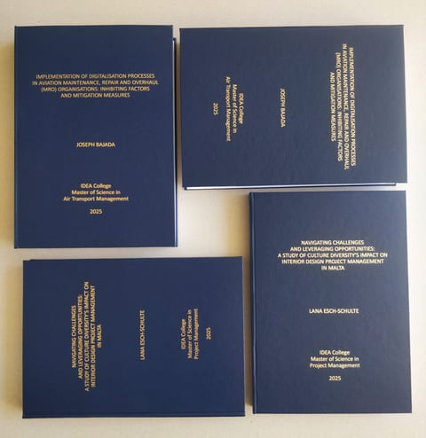 Four blue academic theses displayed, showing covers and spines with gold text from KCA College Master of Science programs from 2025