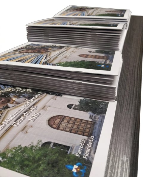 Stacked magazines with white covers and architectural images fanned out on display against a gray textured background