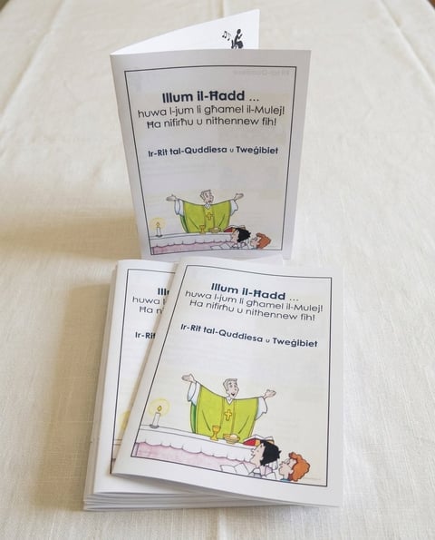Stack of childrens books with illustrated cover showing a character in yellow clothing on a bed with Maltese text title