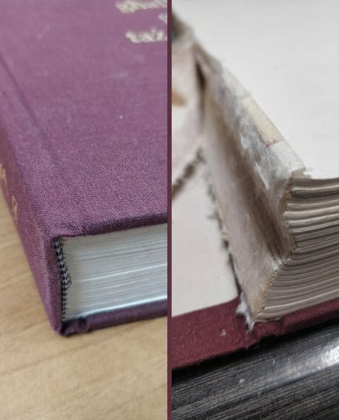 Close-up split view of an open hardcover book with purple cover and visible pages and binding details